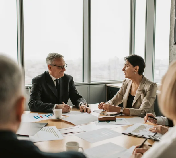 A group of people sitting around a table.